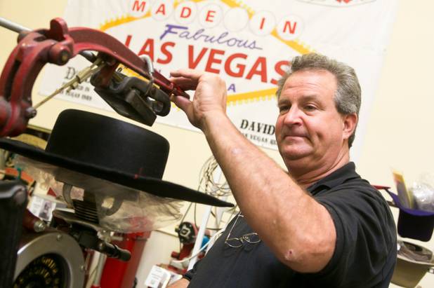 Master Hatter David Johnson irons the crown of a hat on a Crown Iron from the 1920's at D Bar J Hat Company, a Las Vegas based business that makes custom hand-made hats, Wednesday June 5, 2013.